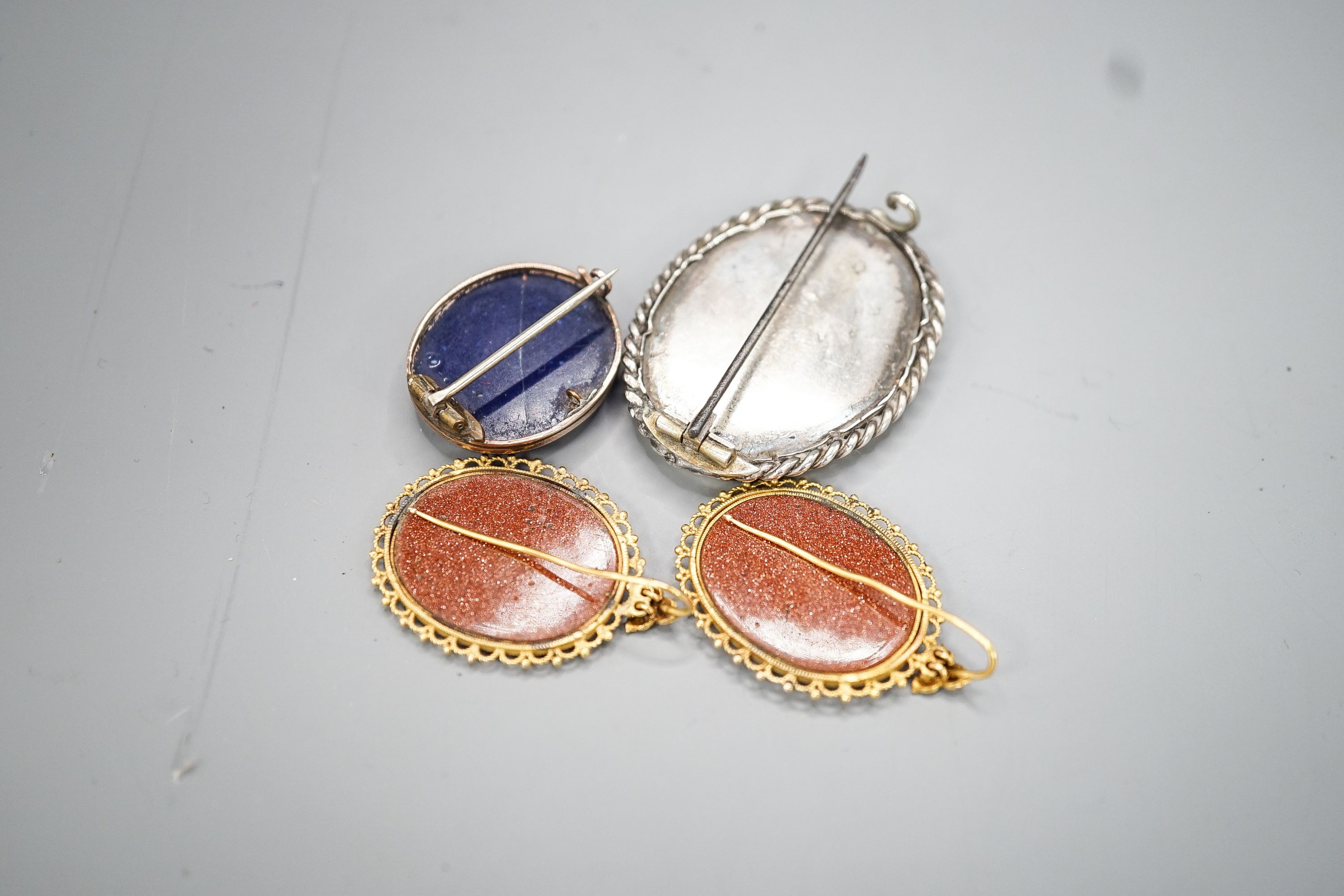 A pair of yellow metal mounted adventurine glass and micro mosaic oval earrings, decorated with ancient architecture, 32mm, a small micro mosaic oval brooch and a white metal mounted adventurine glass and micro mosaic ov